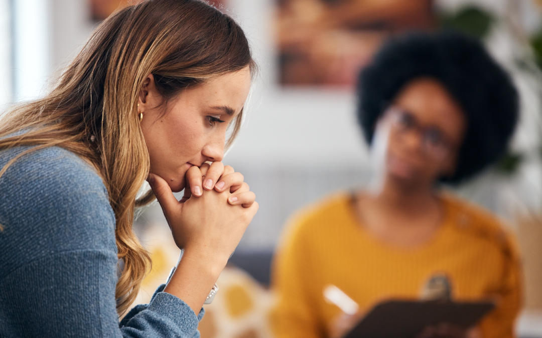 A thoughtful female client discussing her concerns during an individual therapy session with a psychologist in Calgary.